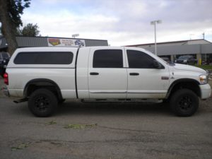 White Dodge Pick Up with cab topper