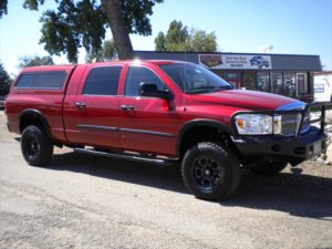Red Dodge Pick Up with cab topper