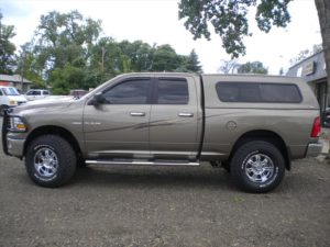 Grey Brown Dodge Pick Up with cab topper