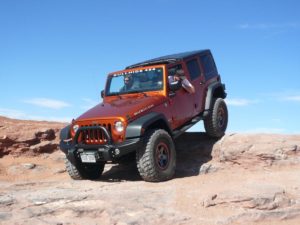 Orange Jeep off-roading