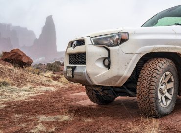 White SUV in rocky desert