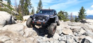 jeep driving off road over rocks